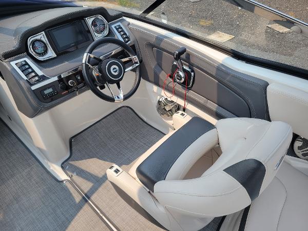 Slide: The Image of 2018 Chaparral 257 SSX boat cockpit with steering wheel and captain's chair. - 7
