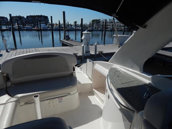 Slide: The Image of 2009 Chaparral 275 SSi boat interior at marina dock, featuring seating and storage. - 14