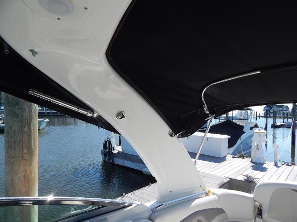 Slide: The Image of 2009 Chaparral 275 SSi boat interior with black canopy at marina. - 15