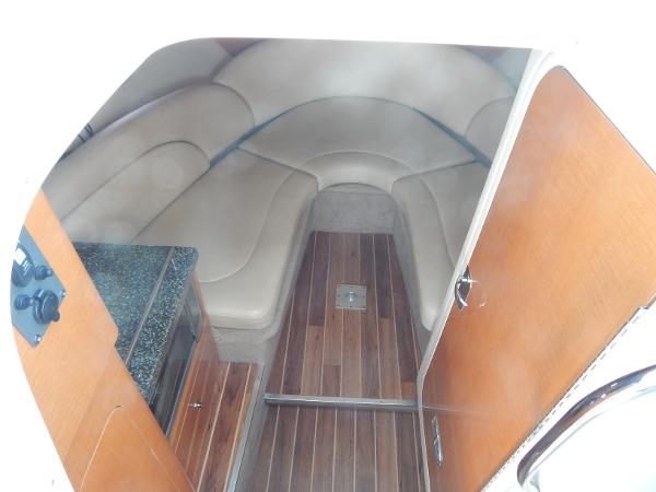 Slide: The Image of 2009 Chaparral 275 SSi cabin interior with wood flooring and cushioned seating. - 16