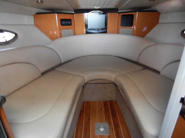 Slide: The Image of 2009 Chaparral 275 SSi boat interior with beige seating and wood accents. - 17