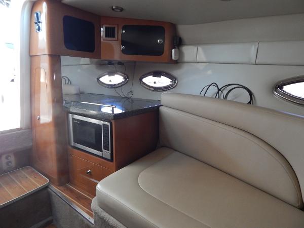 Slide: The Image of 2009 Chaparral 275 SSi interior with kitchenette, microwave, and seating area. - 18