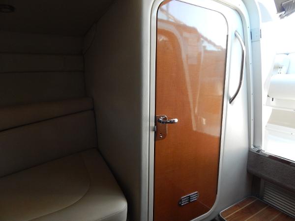 Slide: The Image of 2009 Chaparral 275 SSi cabin interior with wooden door and seating area. - 21