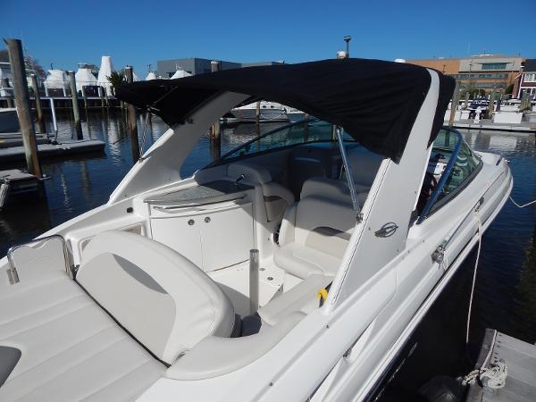 Slide: The Image of 2009 Chaparral 275 SSi boat with black canopy docked at marina. - 4