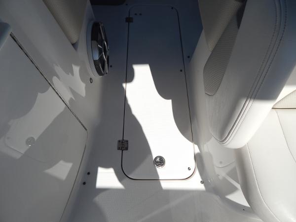 Slide: The Image of 2009 Chaparral 275 SSi boat interior with white seating and floor storage compartment. - 44