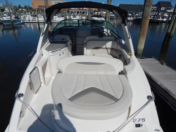 Slide: The Image of 2009 Chaparral 275 SSi boat docked at marina, featuring spacious seating and sleek design. - 5