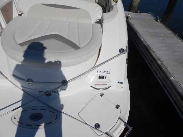Slide: The Image of 2009 Chaparral 275 SSi boat docked, featuring white seating and deck details. - 6