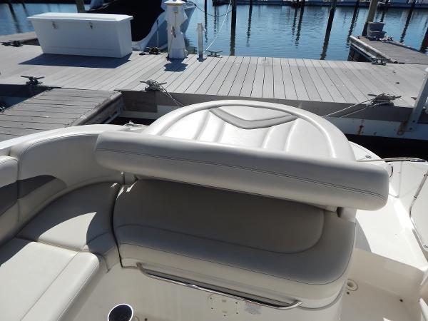 Slide: The Image of 2009 Chaparral 275 SSi boat interior with white leather seating at a marina dock. - 9