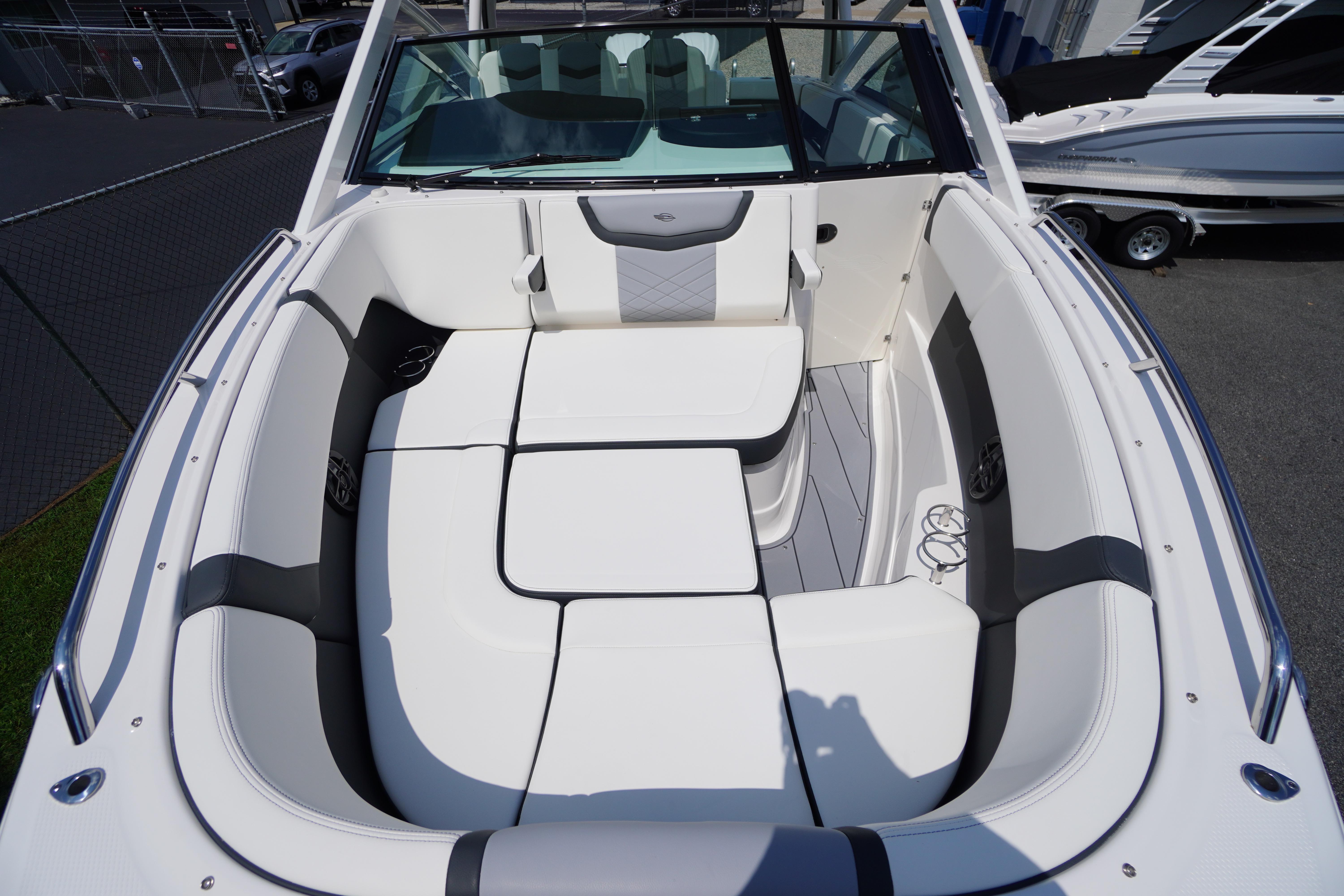 Slide: The Image of 2025 Chaparral 280 OSX boat interior with white and gray seating, showcasing luxury design. - 17