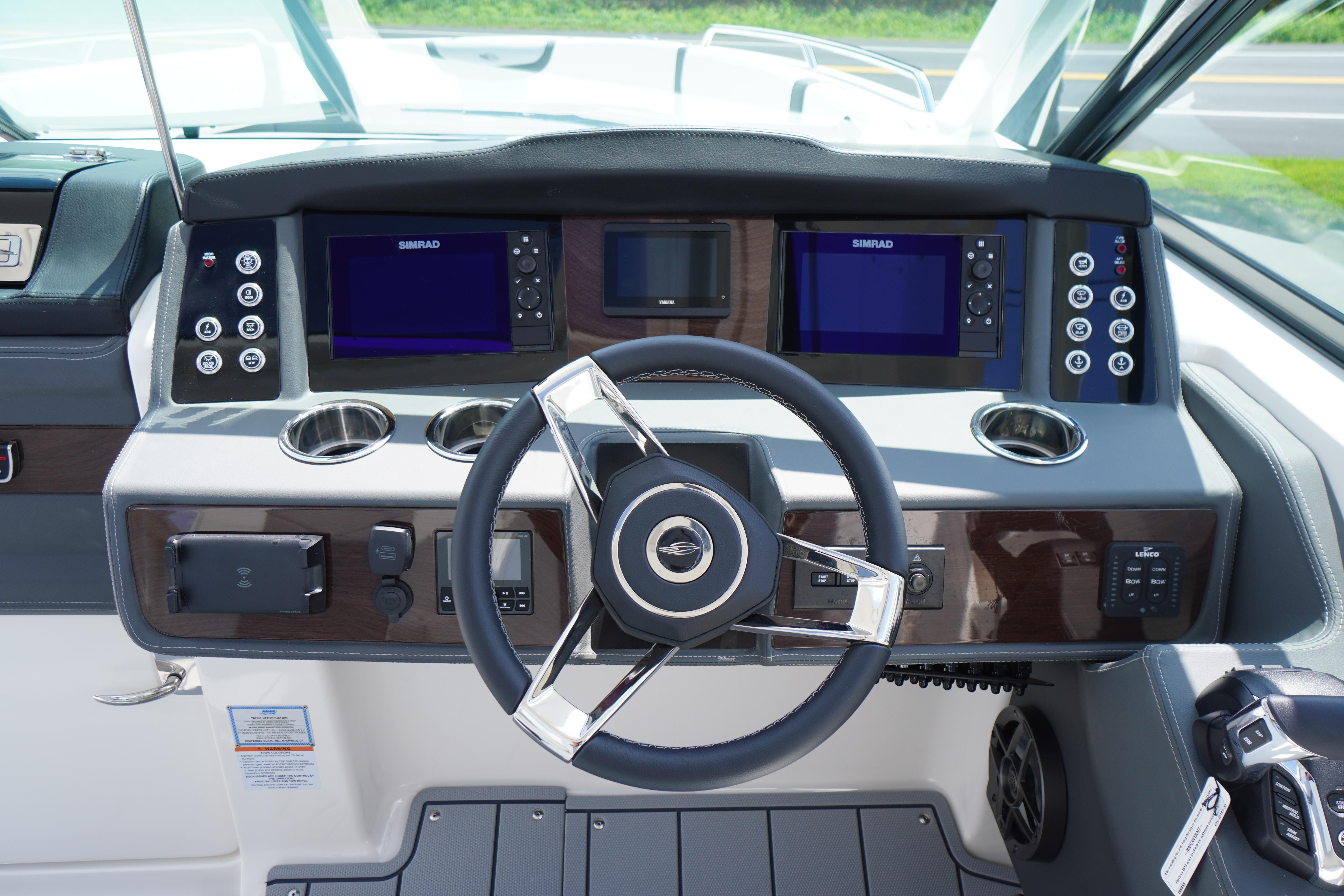 Slide: The Image of 2025 Chaparral 280 OSX helm with dual Simrad displays and modern controls. - 24