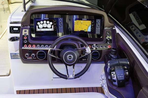 Slide: The Image of Manufacturer Provided Image: 2020 Chaparral 347 SSX boat dashboard with dual navigation screens and steering wheel. - 3