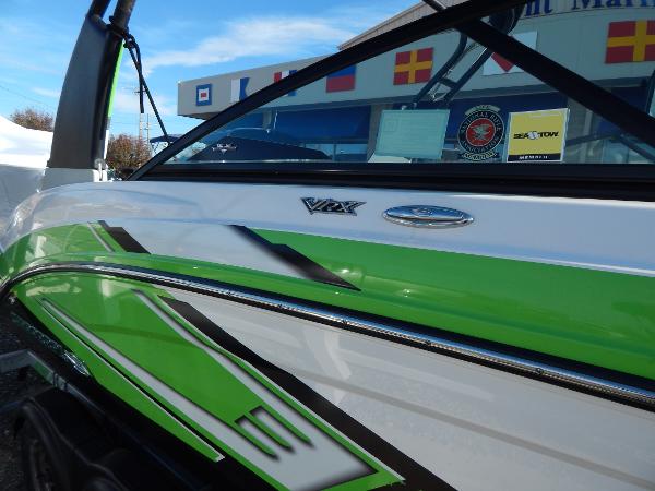Slide: The Image of 2015 Chaparral Vortex 223 VRX boat with green and white exterior. - 10