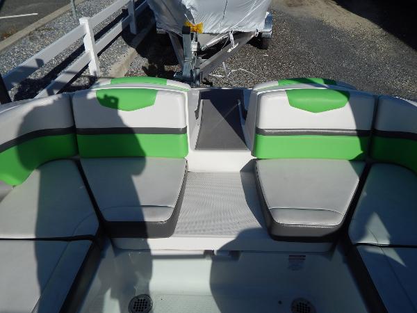 Slide: The Image of 2015 Chaparral Vortex 223 VRX boat interior with green and gray seating. - 13