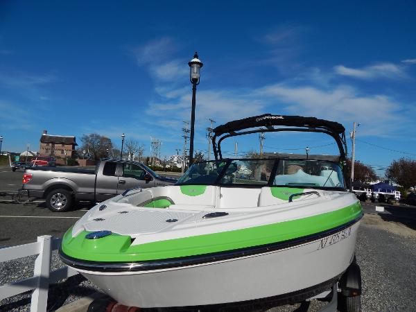 Slide: The Image of 2015 Chaparral Vortex 223 VRX boat with green accents on a trailer. - 3