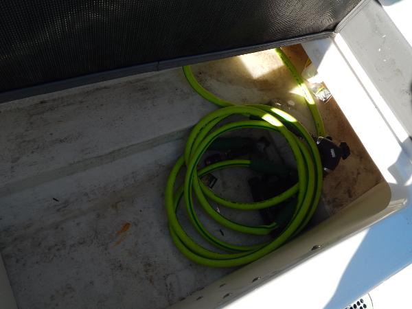 Slide: The Image of Storage compartment with green hose in 2015 Chaparral Vortex 223 VRX boat. - 32