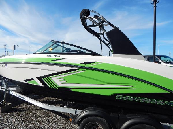 Slide: The Image of 2015 Chaparral Vortex 223 VRX boat with green and white design on trailer. - 5