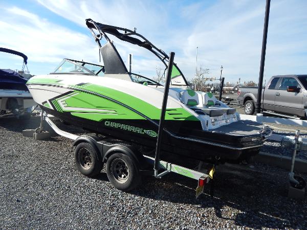 Slide: The Image of 2015 Chaparral Vortex 223 VRX boat on trailer, green and white, parked outdoors. - 6