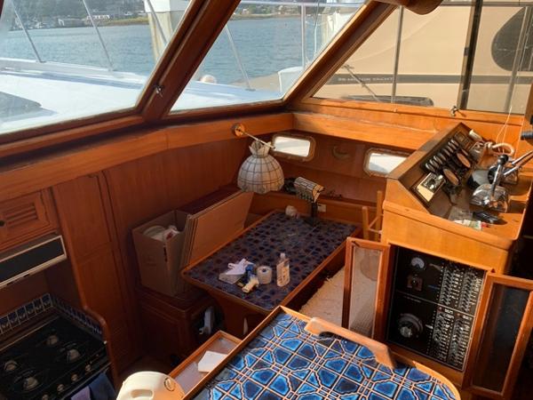 Slide: The Image of 1984 CHB 48 yacht interior with wood paneling and nautical decor. - 16