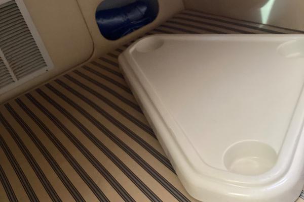 Slide: The Image of Interior of 2001 Chris-Craft 26 Constellation with striped upholstery and triangular table. - 1