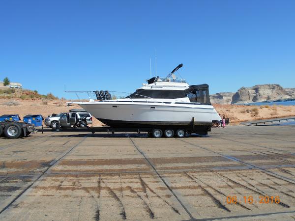 Slide: The Image of 1989 Chris-Craft Amerosport 320 yacht on trailer at a boat launch site. - 1