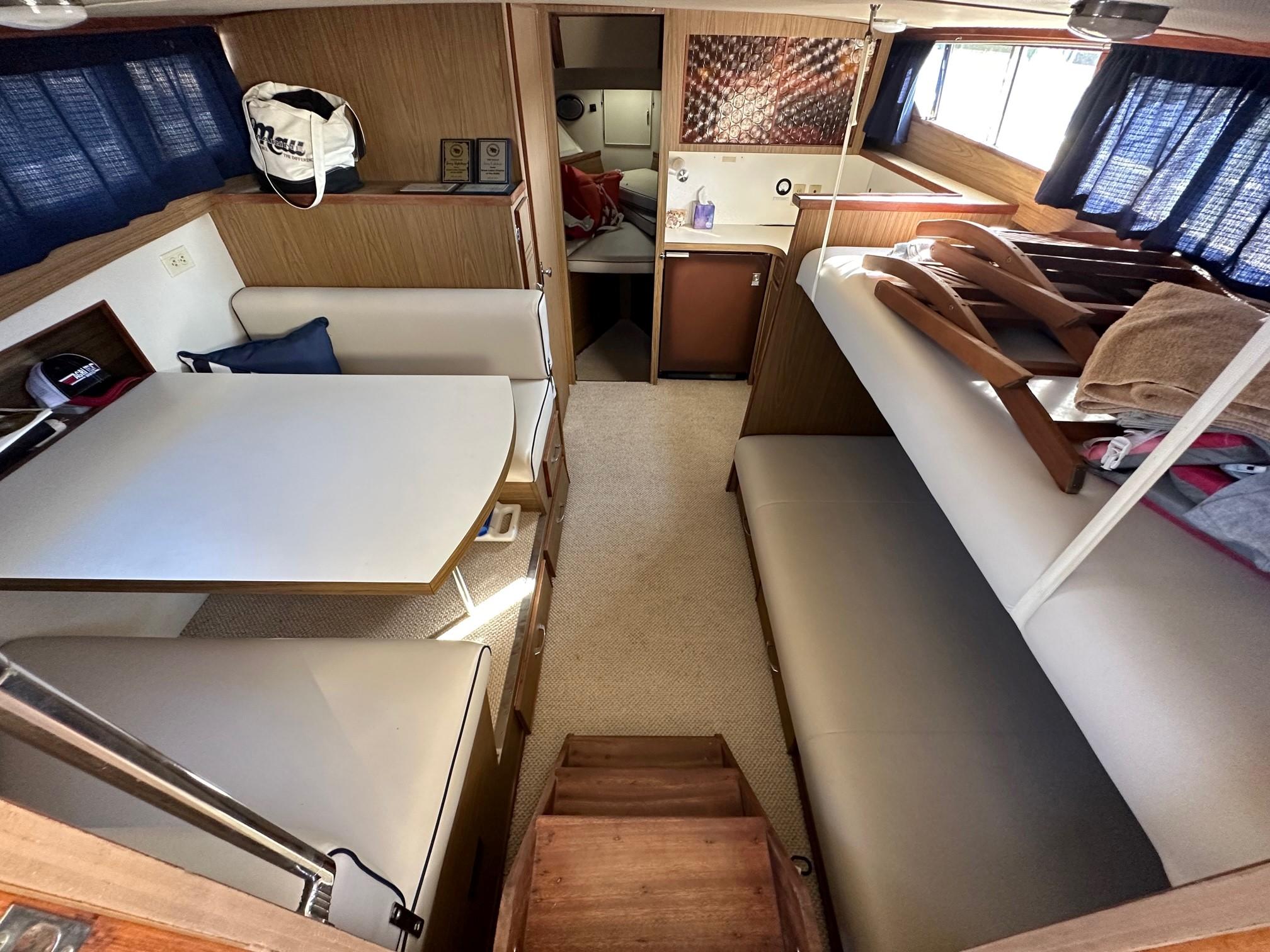 Slide: The Image of Interior of 1968 Chris-Craft 35 Commander with dining area, bunks, and kitchenette. - 13