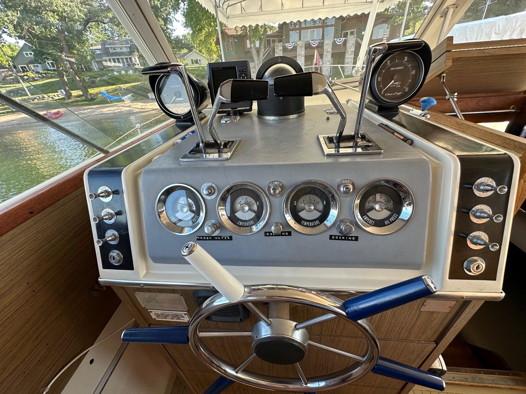 Slide: The Image of 1968 Chris-Craft 35 COMMANDER boat dashboard with gauges and controls. - 17