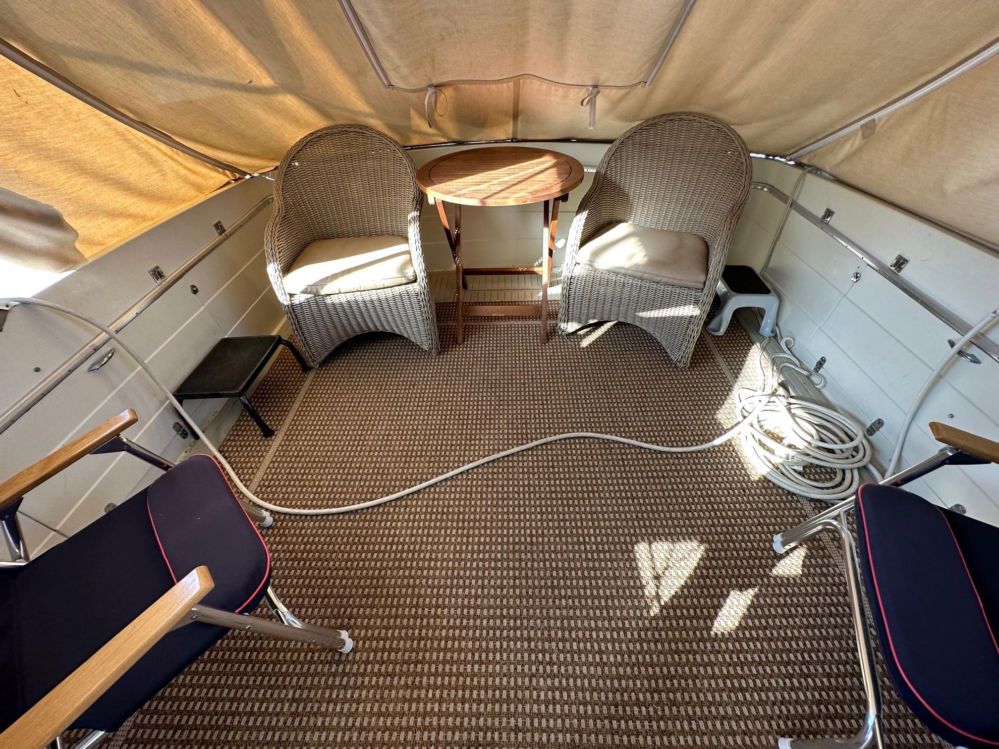 Slide: The Image of Interior of 1968 Chris-Craft 35 COMMANDER with wicker chairs and table under canopy. - 23