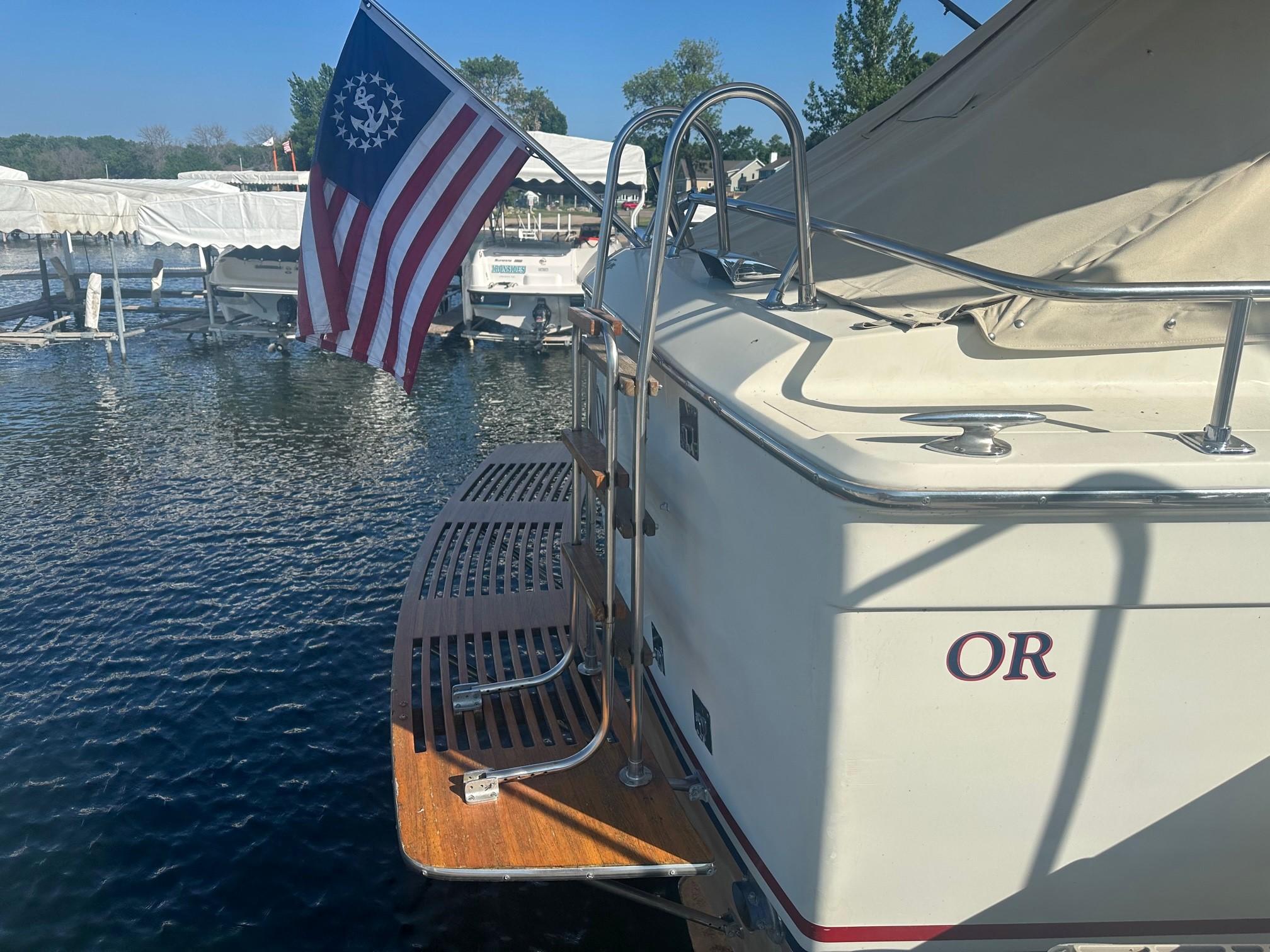 Slide: The Image of 1968 Chris-Craft 35 COMMANDER boat docked with American flag. - 28
