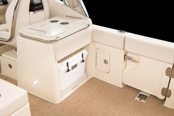 Slide: The Image of 2024 Chris-Craft Calypso 24 boat interior with storage compartments and Yeti cooler. - 3