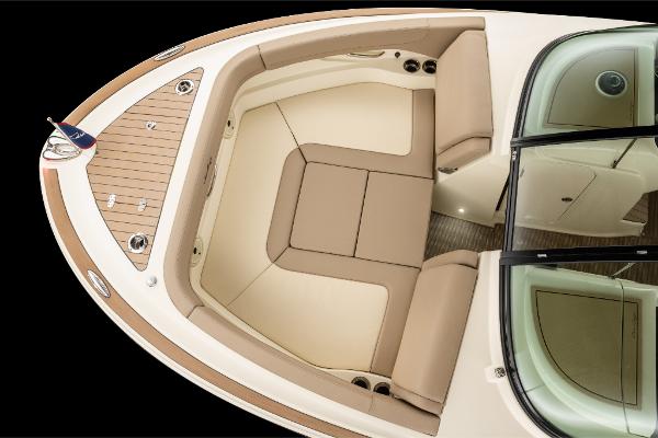 Slide: The Image of 2023 Chris-Craft Calypso 27 boat interior with beige seating and wooden deck. - 10