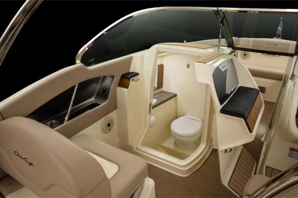 Slide: The Image of 2023 Chris-Craft Calypso 27 boat interior with seating and toilet area. - 17
