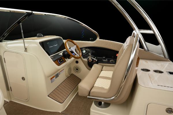 Slide: The Image of 2023 Chris-Craft Calypso 27 boat interior with beige seating and modern dashboard. - 25