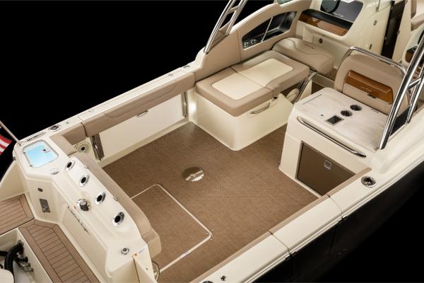 Slide: The Image of 2023 Chris-Craft Calypso 27 boat interior with beige seating and modern amenities. - 4