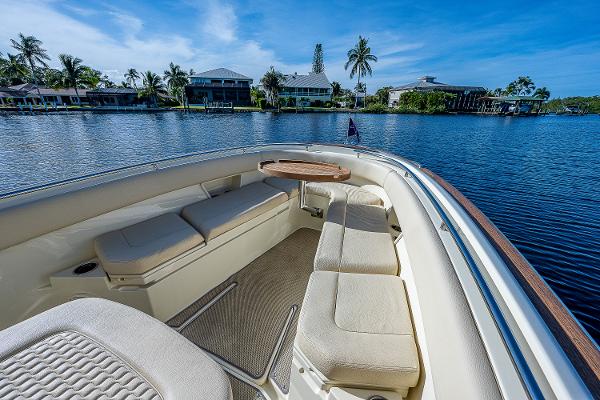 Slide: The Image of 2019 Chris-Craft Catalina 27 boat interior with luxurious seating on a serene waterfront. - 10