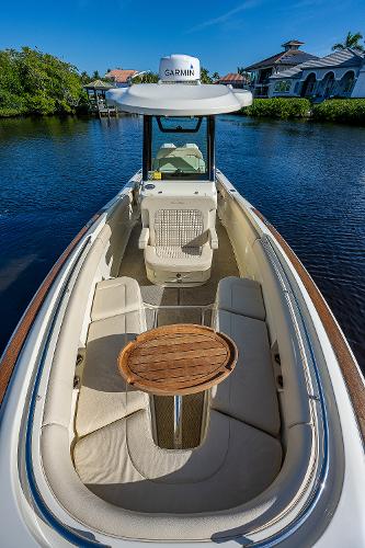 Slide: The Image of 2019 Chris-Craft Catalina 27 boat with Garmin equipment, docked on a serene waterway. - 15