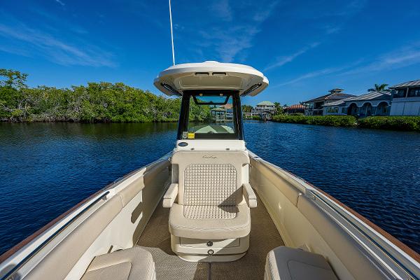 Slide: The Image of 2019 Chris-Craft Catalina 27 boat on calm water, clear sky, luxurious seating. - 16