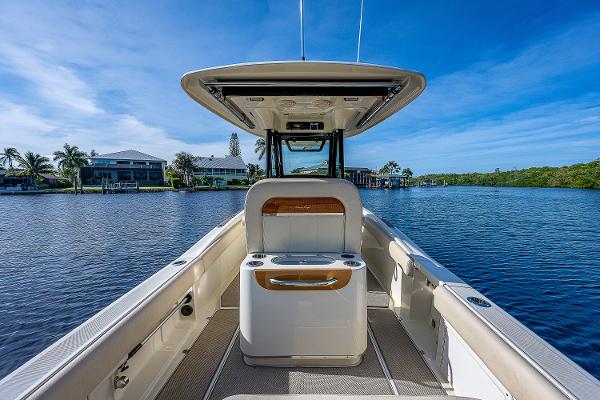 Slide: The Image of 2019 Chris-Craft Catalina 27 boat on serene water, showcasing sleek design and spacious deck. - 24