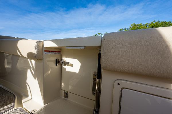 Slide: The Image of 2019 Chris-Craft Catalina 27 interior detail with beige upholstery and blue sky background. - 25