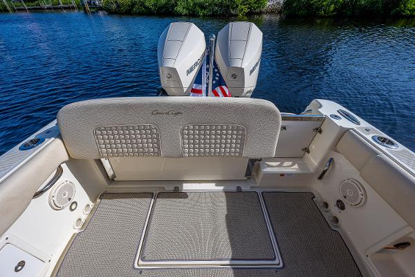 Slide: The Image of 2019 Chris-Craft Catalina 27 boat interior with twin Mercury engines on a calm lake. - 30