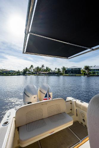 Slide: The Image of 2019 Chris-Craft Catalina 27 boat with dual Mercury engines on a sunny waterfront. - 31