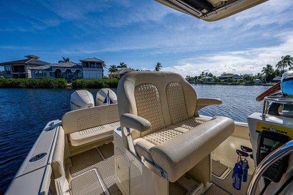 Slide: The Image of 2019 Chris-Craft Catalina 27 boat interior with luxurious seating, overlooking serene waterfront homes. - 37