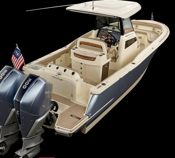 Slide: The Image of 2024 Chris-Craft Catalina 28 boat with dual outboard engines, luxury interior, and American flag. - 0
