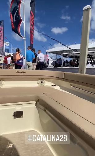 Slide: The Image of 2024 Chris-Craft Catalina 28 boat at a marina event with people and flags. #Catalina28 - 11