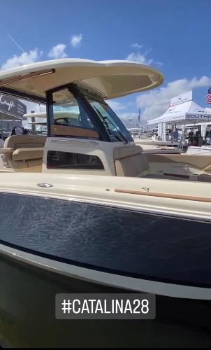 Slide: The Image of 2024 Chris-Craft Catalina 28 boat at a marina with #Catalina28 hashtag. - 4