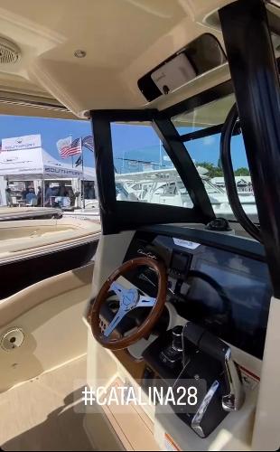 Slide: The Image of 2024 Chris-Craft Catalina 28 helm station with wooden steering wheel and modern controls. #Catalina28 - 7