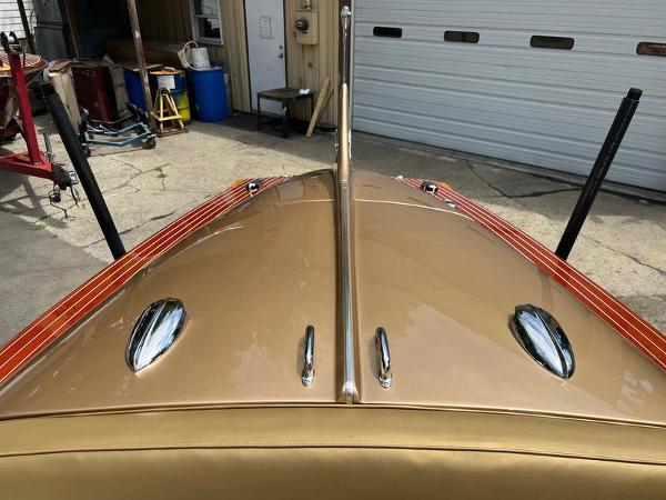 Slide: The Image of 1955 Chris-Craft Cobra 21 boat with sleek gold finish and chrome details. - 10