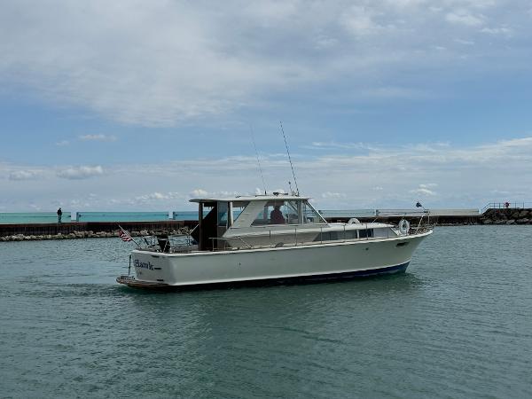 Slide: The Image of 1969 Chris-Craft Commander boat cruising on calm waters under a cloudy sky. - 17