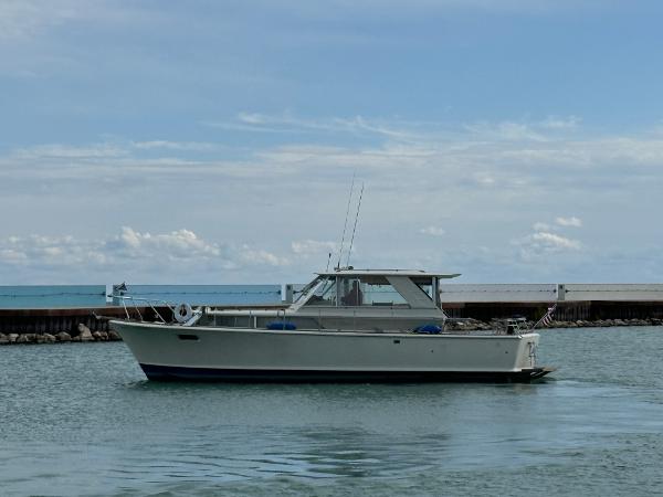 Slide: The Image of 1969 Chris-Craft Commander boat on calm water under a clear sky. - 26