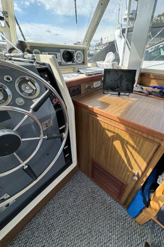 Slide: The Image of 1969 Chris-Craft Commander boat interior with steering wheel and wooden dashboard. - 48