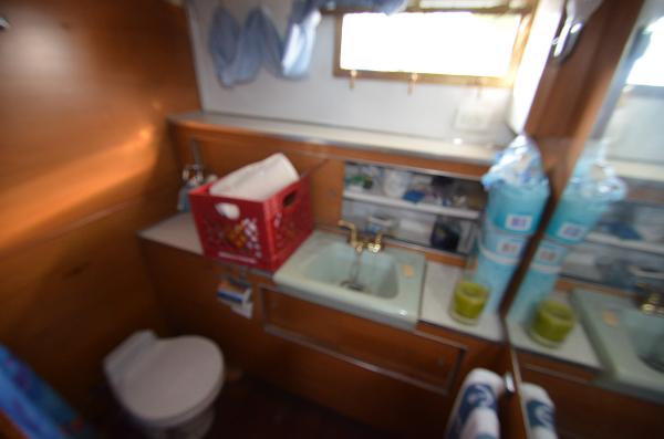 Slide: The Image of 1964 Chris-Craft Constellation bathroom with sink, toilet, and storage. - 19